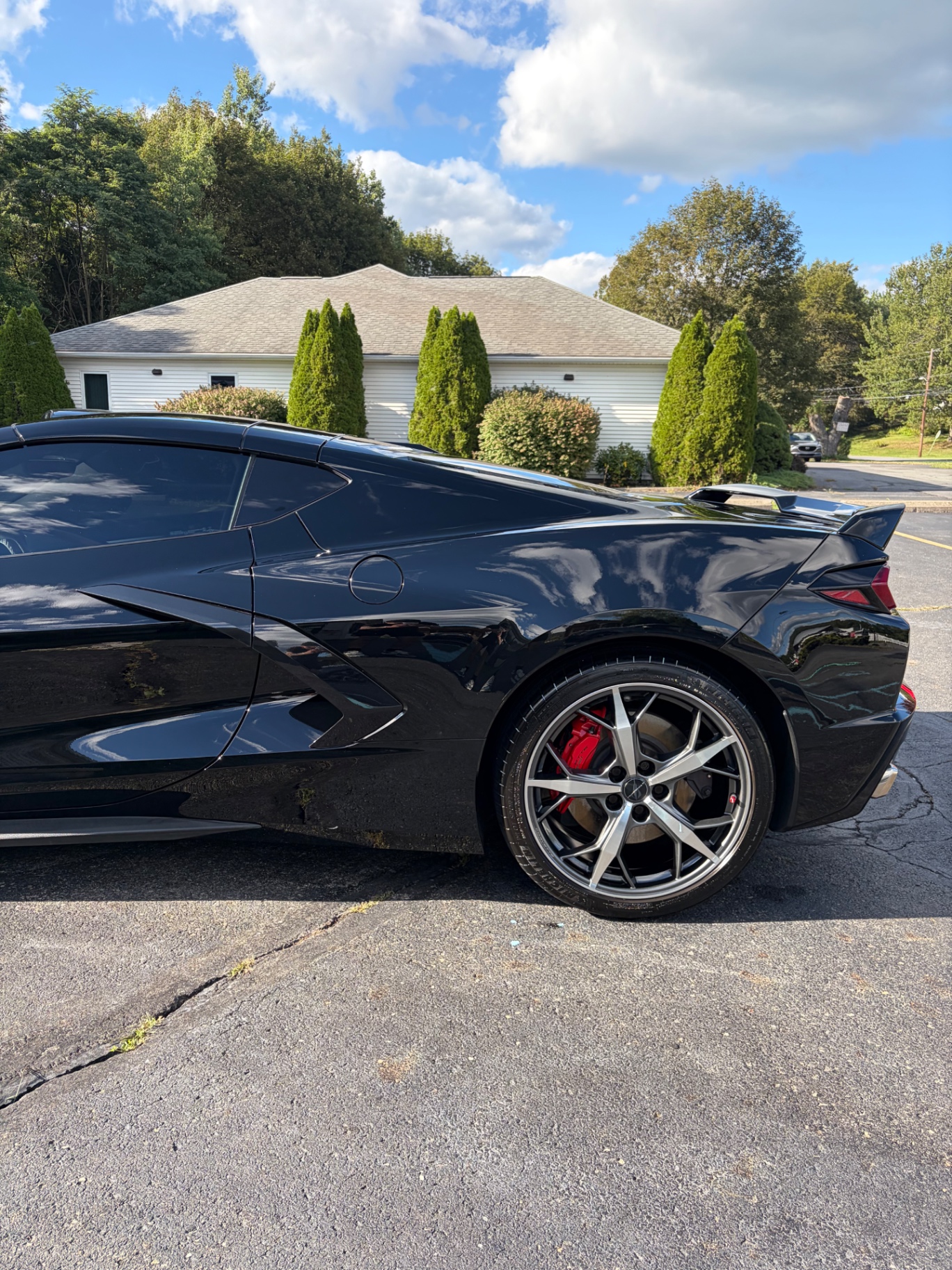 Black Chevrolet Corvette C8 side profile showing high-gloss paint