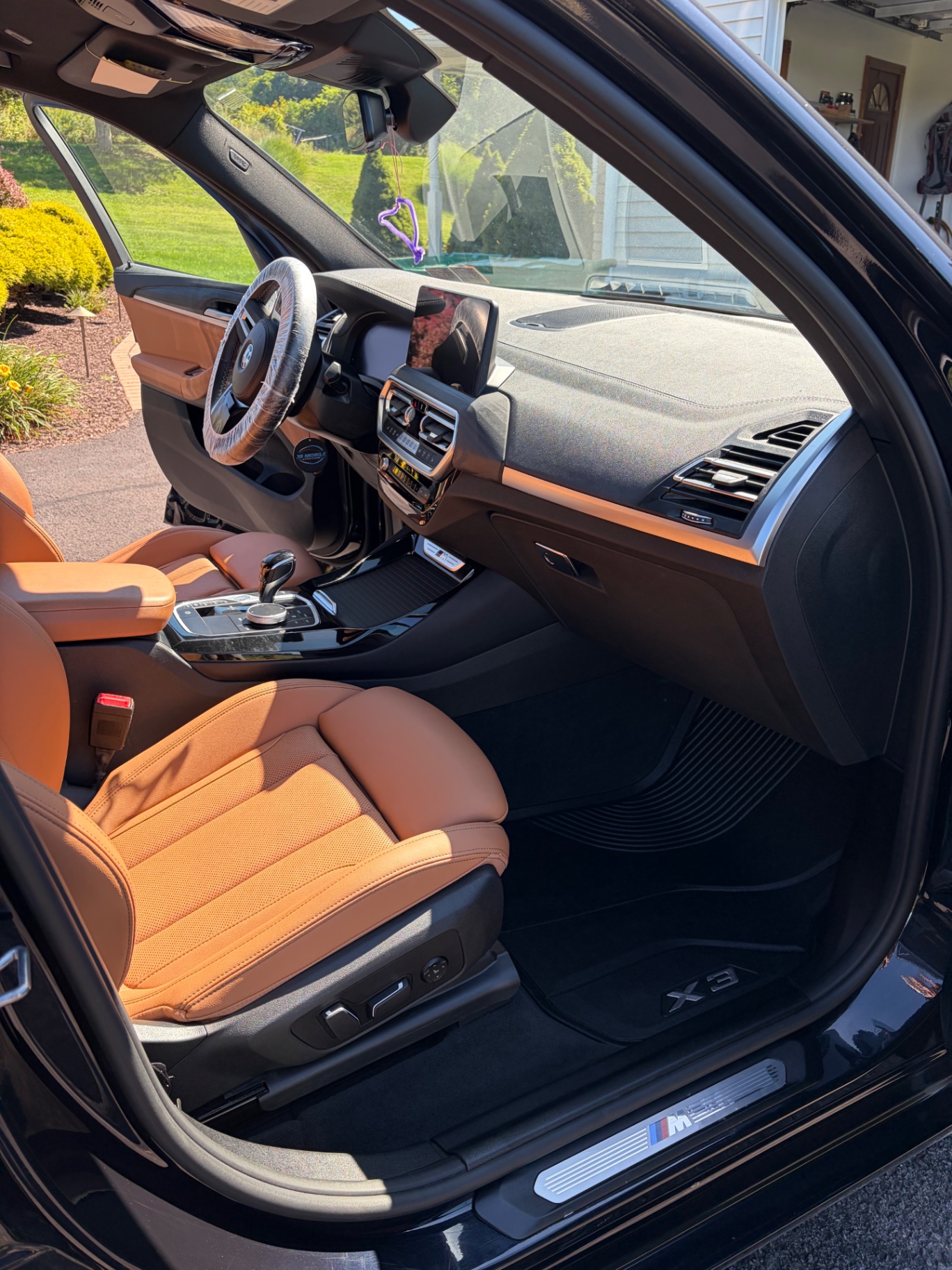 BMW X3 passenger side cognac leather seat and dashboard after detail