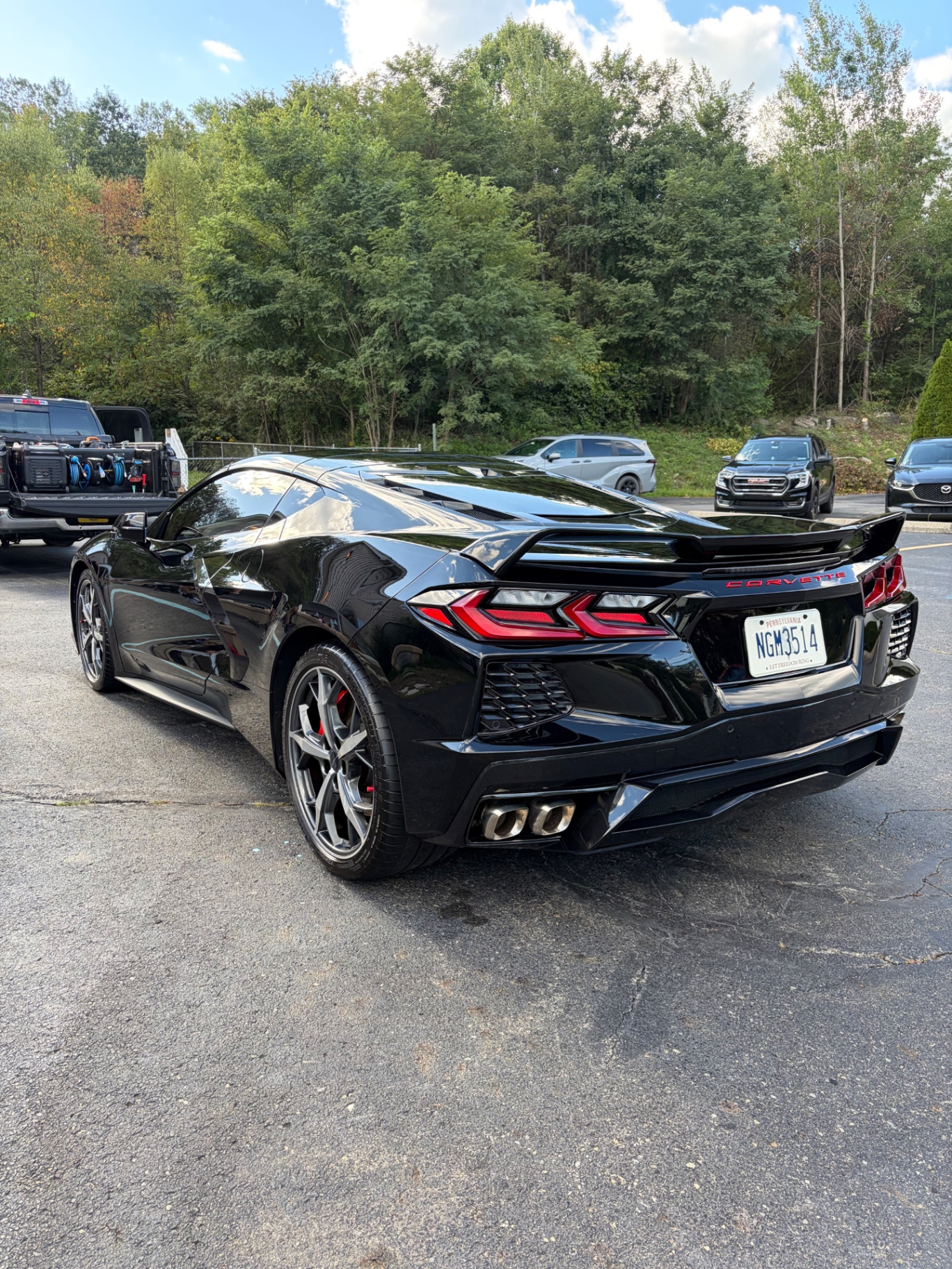 Black Chevrolet Corvette C8 rear with quad exhaust tips after detail