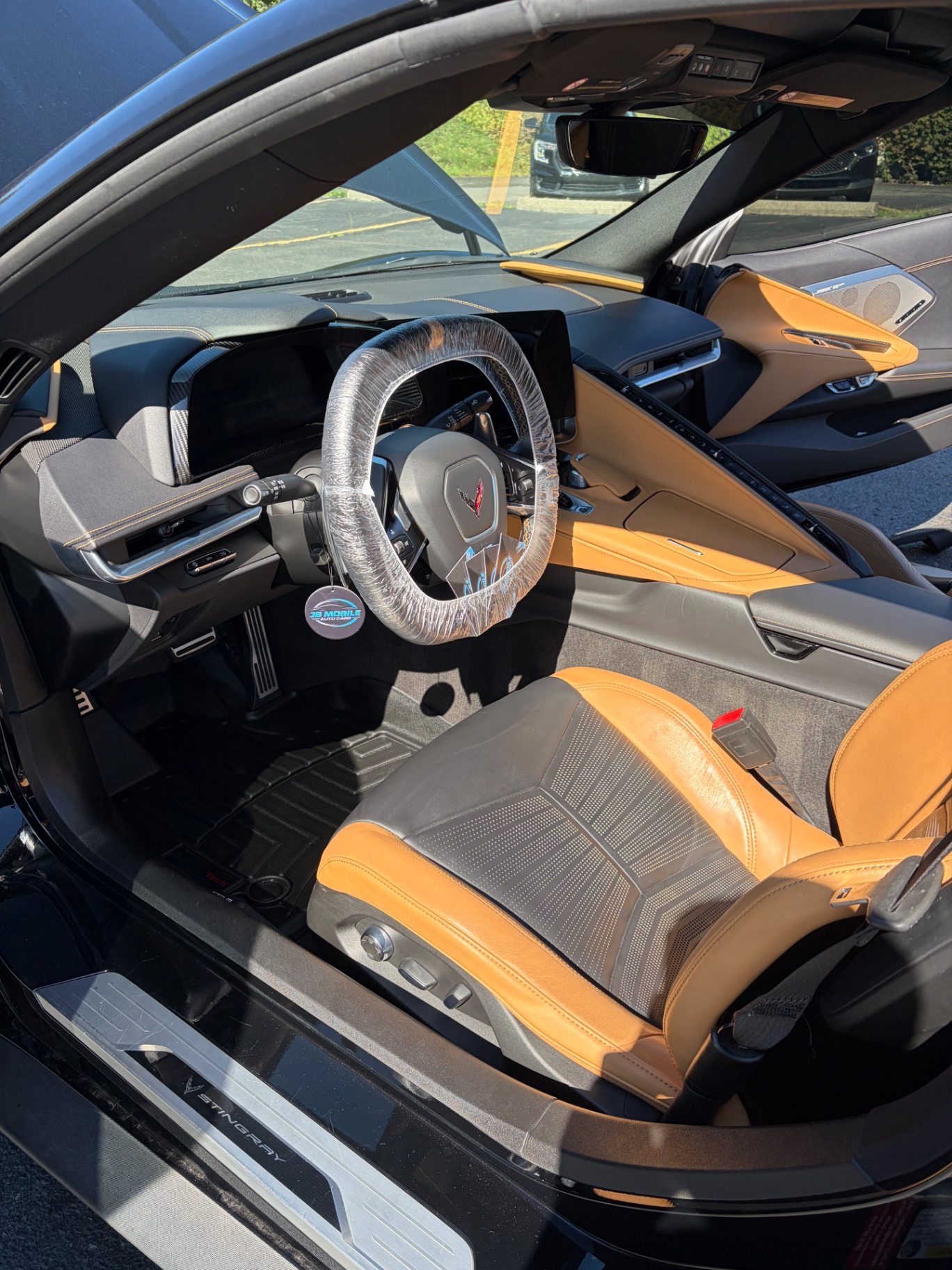 Chevrolet Corvette Stingray interior with protective-wrapped steering wheel