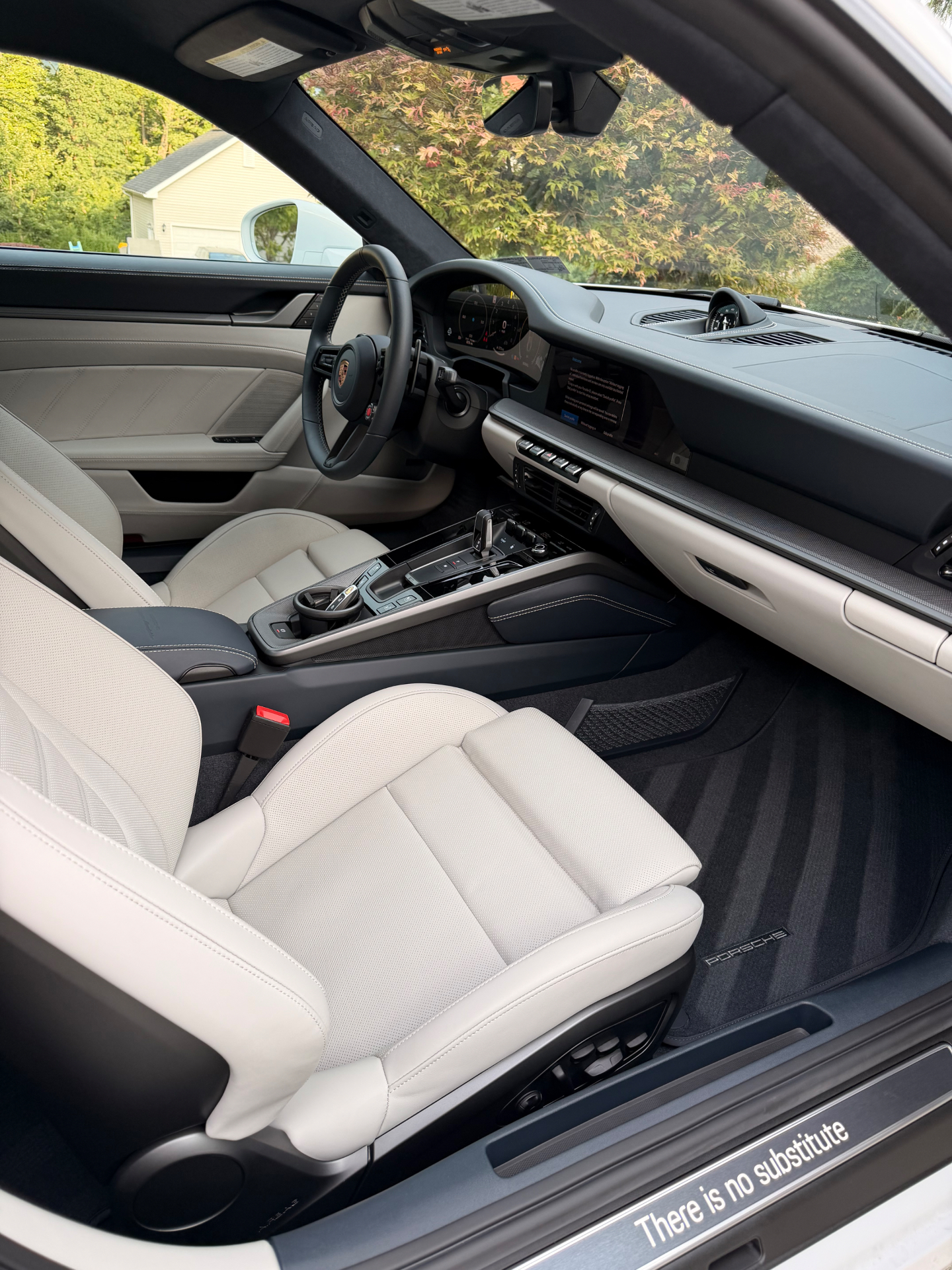 Porsche interior with vacuumed floor mats after a detail