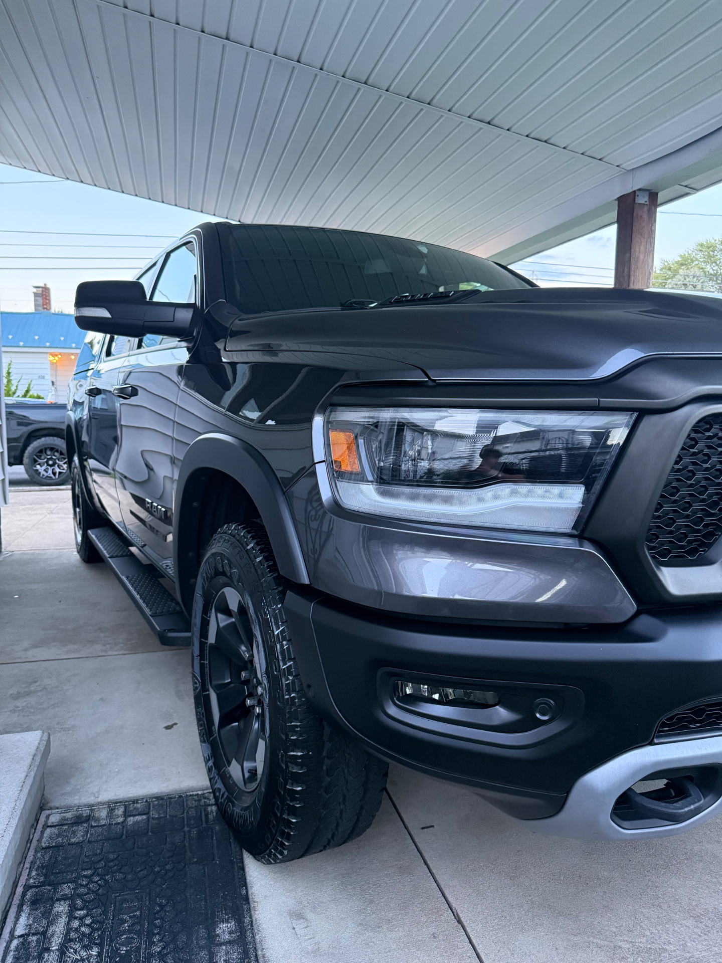 Gray Ram pickup headlight and front wheel after exterior detail