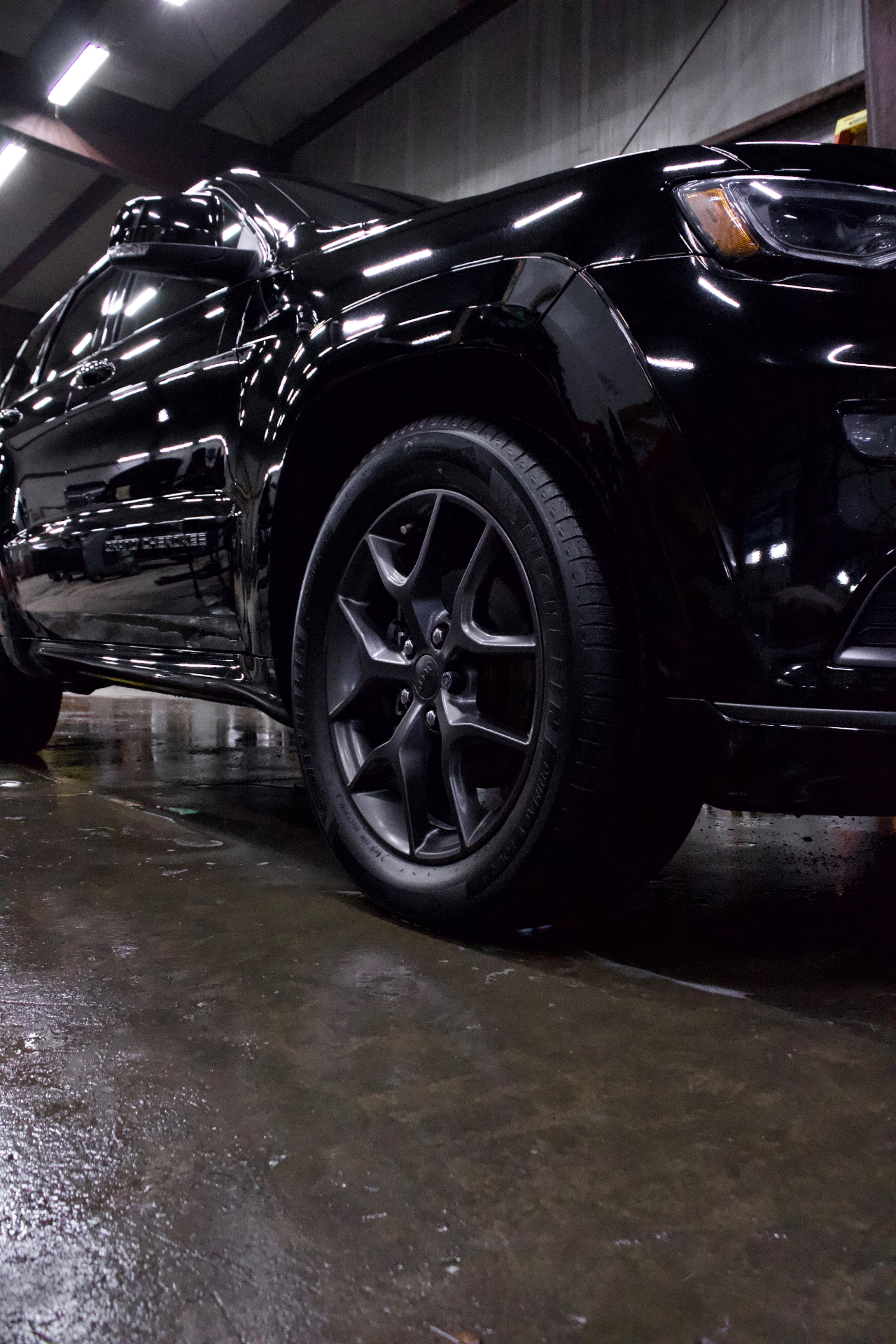 Black Jeep Grand Cherokee wheel after detail